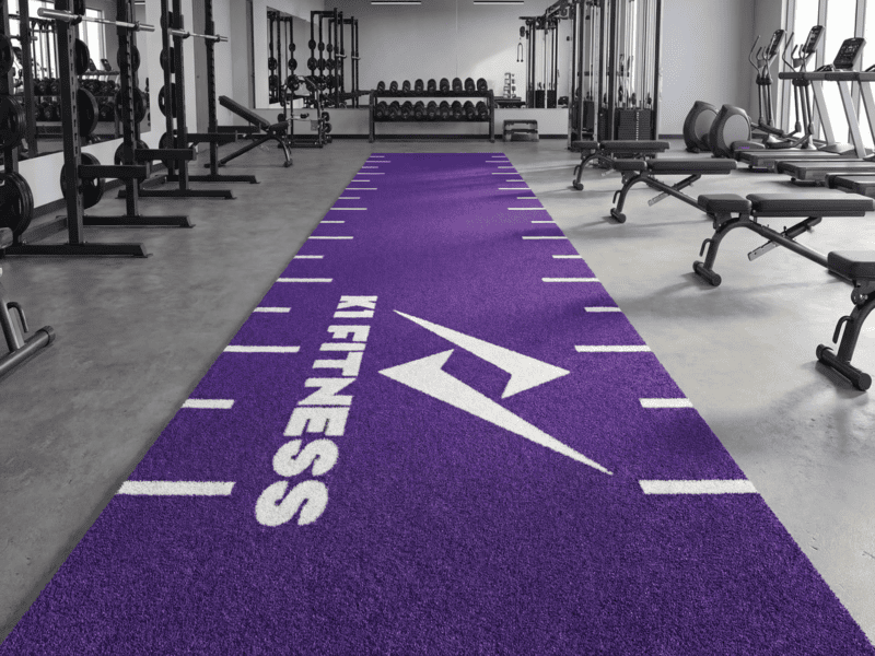 Synthetic gym turf installation showing sled training